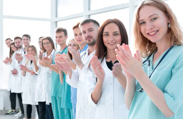 top view. a group of smiling doctors pointing at you.