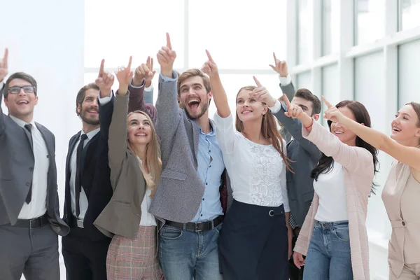 Close up. group happy young people, pointing far the upward — Stock Photo, Image