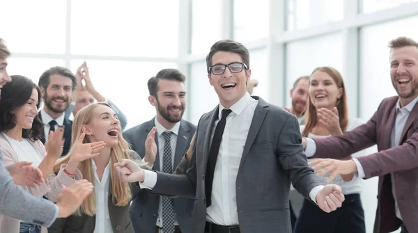 Happy young businessman standing in front of his business team. — Stock Photo, Image