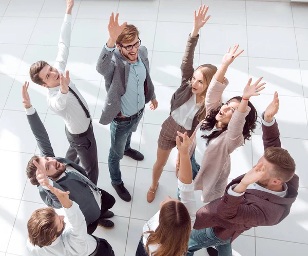 Top view. successful business team standing in a circle with hands up. — ストック写真