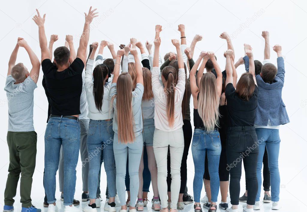 group of diverse young people standing with hands up