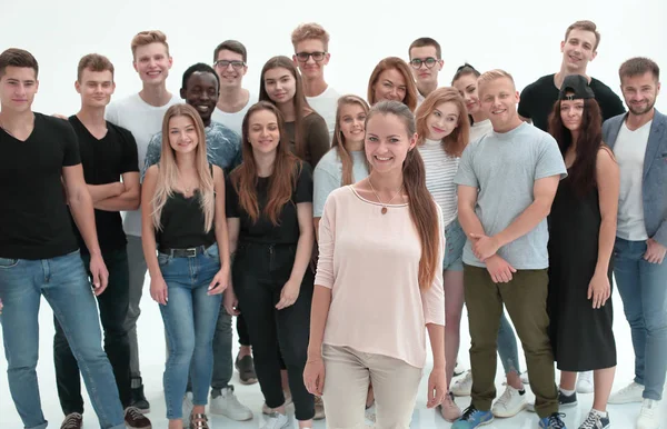 Smiling young woman standing in front of her team — Stock Photo, Image