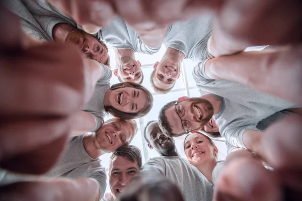 Bottom view. group of successful young people looking at the camera — Stock Photo, Image