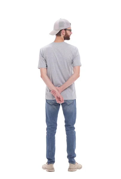 Rear view. casual guy in cap reading ad on white wall — Stock Photo, Image