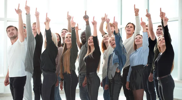 Group of young business people pointing up — Stock Photo, Image