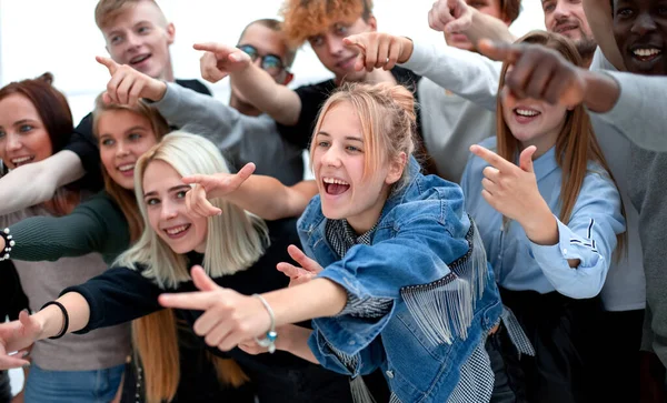 Close up. a group of young people pointing at one point — Stock Photo, Image