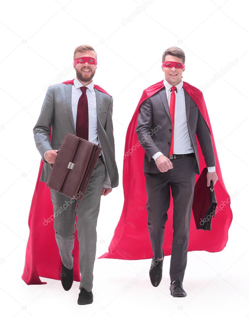 business partners in superhero capes walking together.