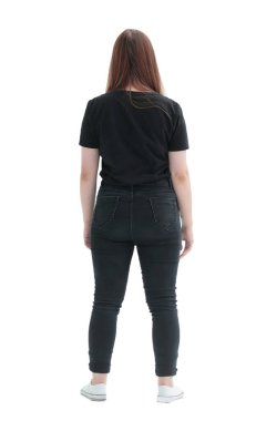 Yan görünüş. Sıradan bir genç kadın boş bir duvara bakıyor.