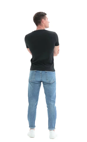 Visão traseira. cara em uma camiseta preta olhando para uma parede branca — Fotografia de Stock