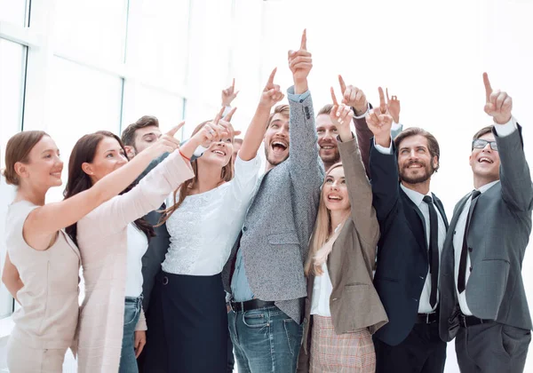 Group of confident young people, pointing somewhere up. — Stock Photo, Image