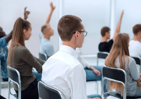 Diverse jongeren applaudisseren terwijl ze op dezelfde rij zitten — Stockfoto