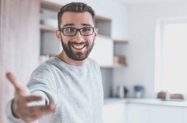 Kapat. Genç adam mutfakta duruyor.