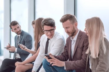 Genç çalışanlar haberleri internetten izlemek için akıllı telefonlarını kullanıyorlar.