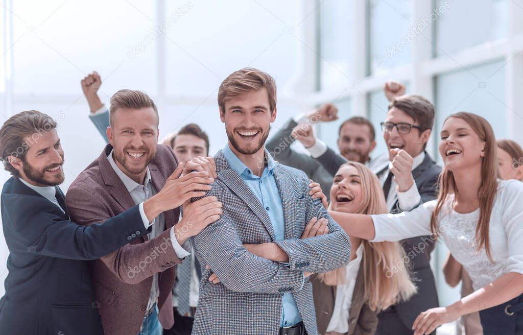 close up. cheerful company employees applauding their colleague.