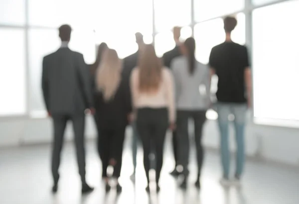 background image of a group of business people standing in the office