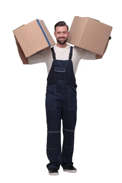 In full growth. a smiling man with cardboard boxes on his shoulders — Stock Photo, Image