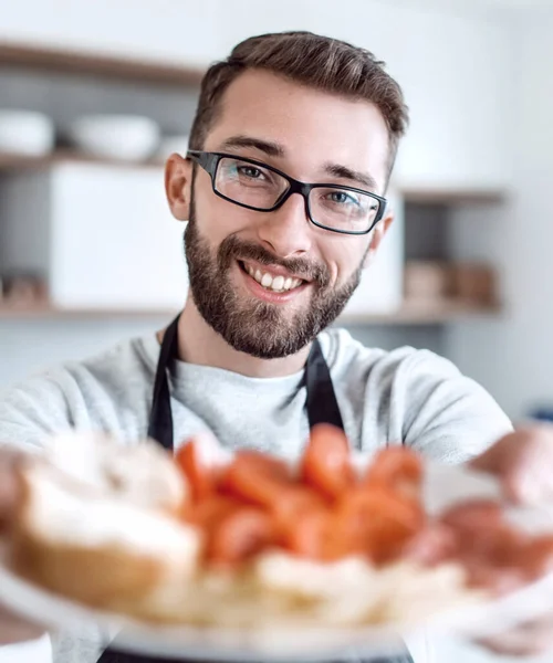 Plate of sandwiches in the hands of an attractive man — Stock Photo, Image