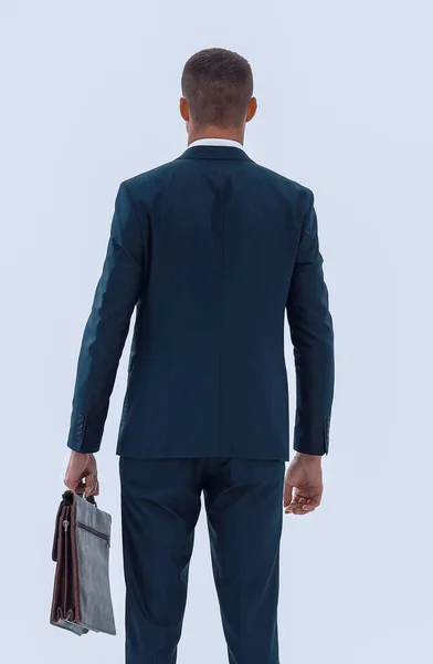 Detrás view.confident hombre de negocios con maletín —  Fotos de Stock
