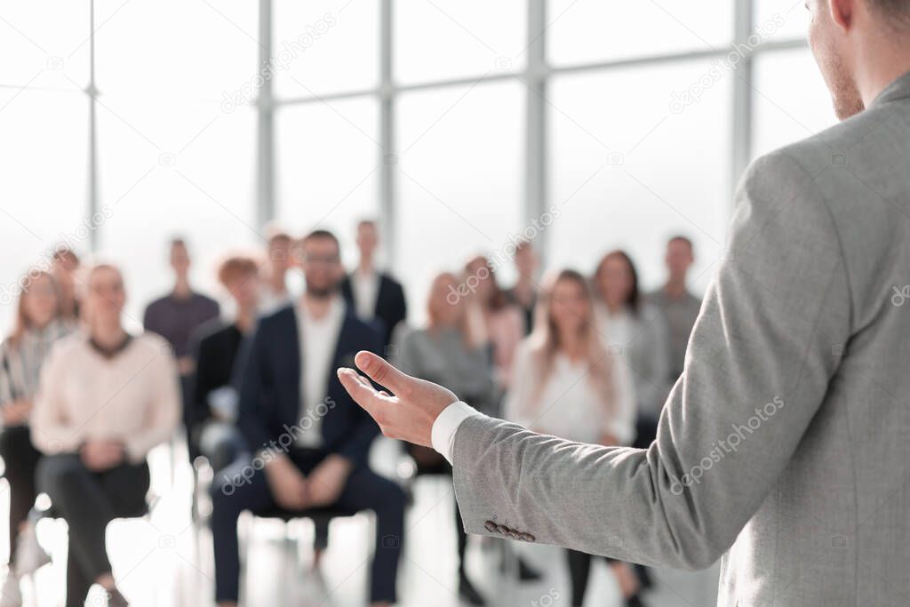 image of a speaker giving a lecture at a business seminar