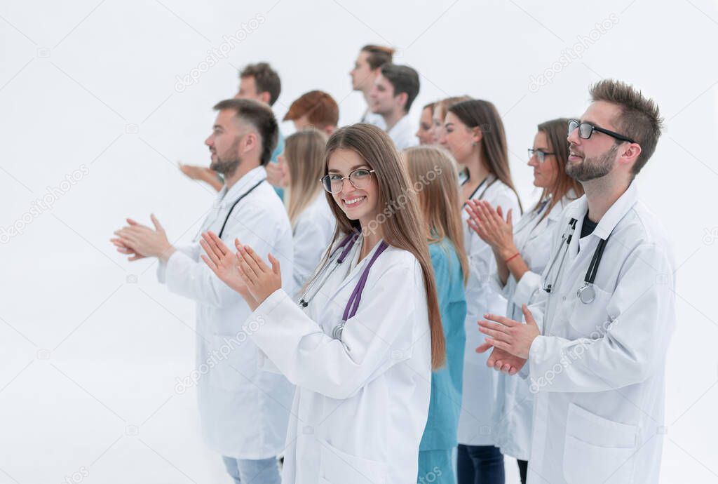 female doctor and her colleagues give a standing ovation
