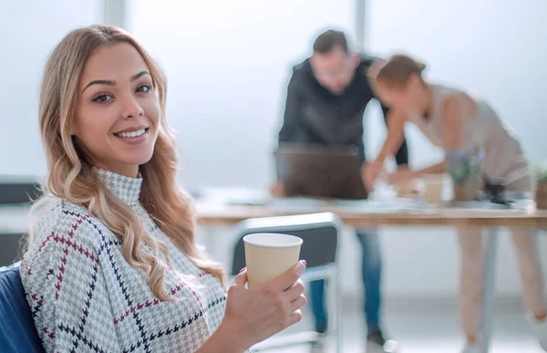 young business woman with a Cup of coffee in a modern office