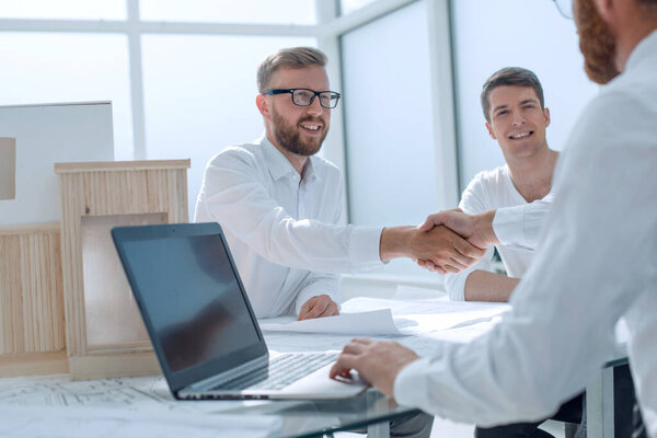 business people shaking hands in the architectural office