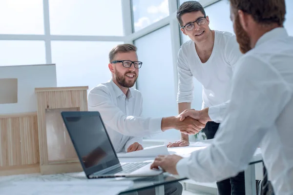 Business people shaking hands in the architectural office — Stock Photo, Image