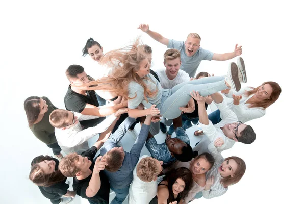 Happy team of young people rocking their leader. — Stock Photo, Image