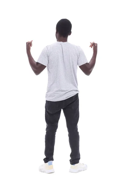 Bakifrån. ung man står framför vit vägg — Stockfoto