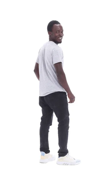 Οπίσθια όψη. νεαρός άνδρας στέκεται μπροστά από το λευκό τοίχο — Φωτογραφία Αρχείου