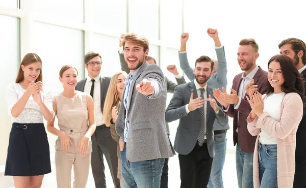 Happy business man standing among colleagues and pointing at you. — Stock Photo, Image