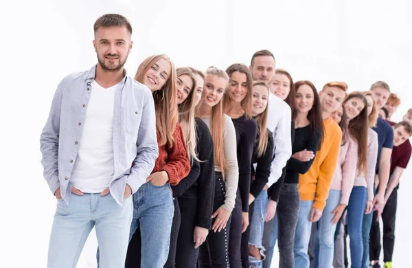 Handsome guy standing in front of a group of young people — Stock Photo, Image