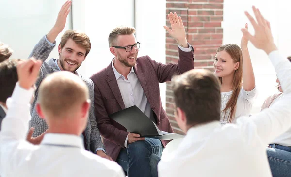 Corporate team votes during a business meeting. — Stock Photo, Image