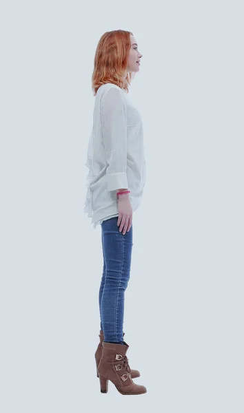 Vista lateral. mujer joven de moda segura en jeans y botas altas — Foto de Stock
