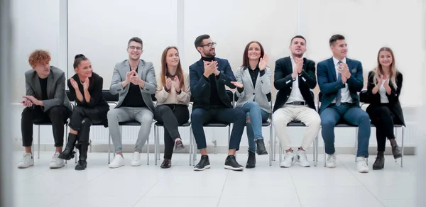 Grupo de empresários diversos aplaudindo sentado em uma fileira. — Fotografia de Stock