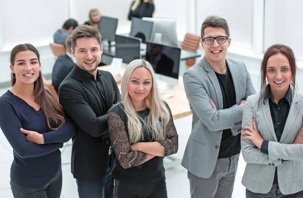 Team of confident young people standing in the office standing in the office — Stock Photo, Image