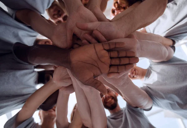 Des jeunes souriants qui font une grande tour de leurs mains — Photo