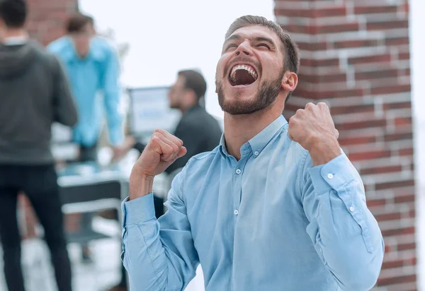 Hombre de negocios guapo celebrando la victoria gritando felizmente en th — Foto de Stock