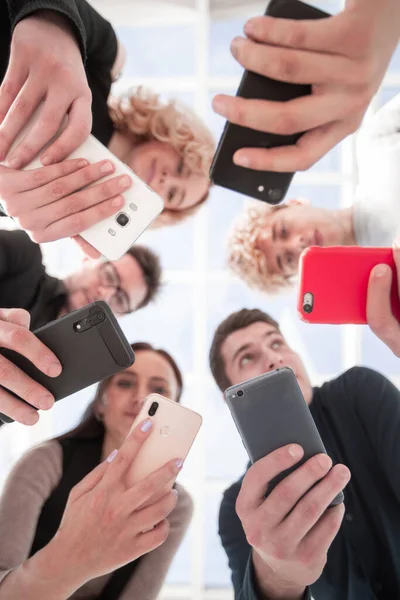 Group of businessman hold smartphones. bottom view