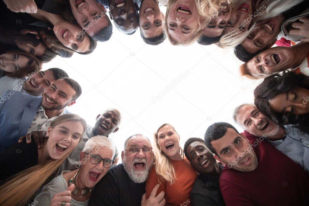 Smiling multiethnic group look down at the camera