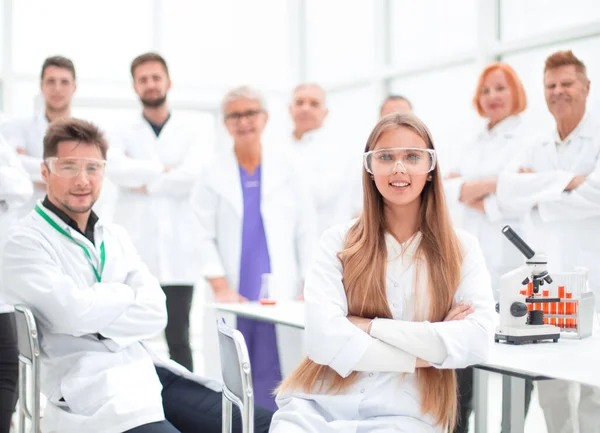 Young researcher and his colleagues in the workplace — Stock Photo, Image