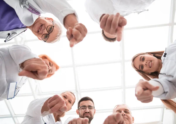 Group of doctors standing in a circle and pointing at you . — Stock Photo, Image