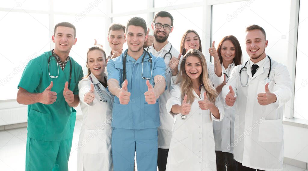 diverse medical professionals giving a thumbs up