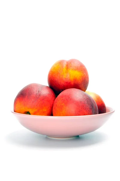 Ripe peaches in bowl isolated on white — Stock Photo, Image