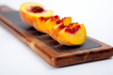 Şeftali bir kesme tahtası üzerinde parçaları