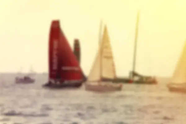 Yachts a sailing regatta at the sea during sunset . Blurred imag — Stock Photo, Image