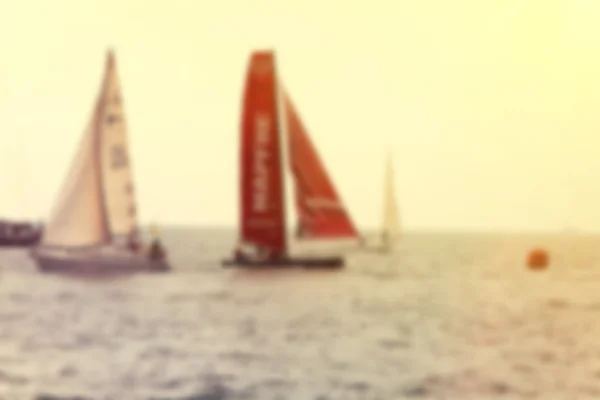 Yachts a sailing regatta at the sea during sunset . Blurred imag — Stock Photo, Image