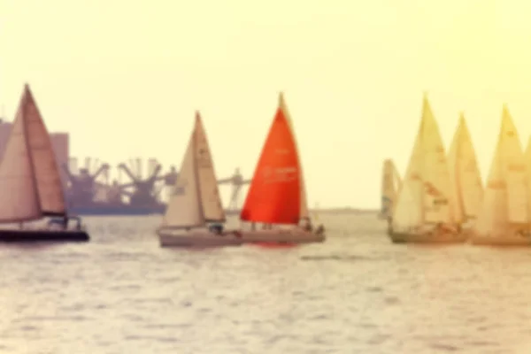 Yachts a sailing regatta at the sea during sunset . Blurred imag — Stock Photo, Image