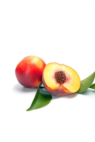 One and a half nectarine peaches isolated on white background — Stock Photo, Image