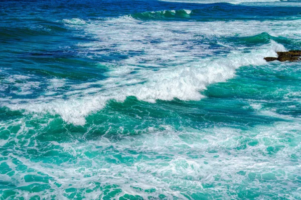 Salpicaduras de agua de mar con olas espumosas. Textura de superficie de agua . — Foto de Stock